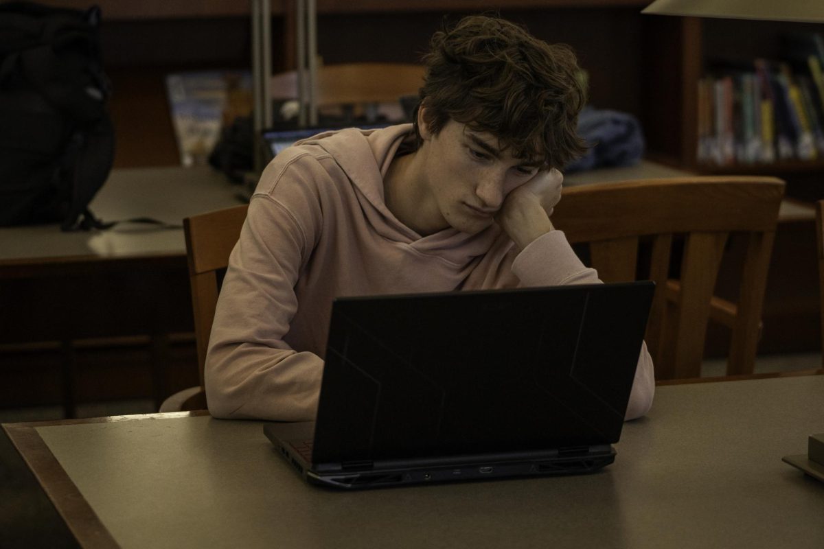 Zach Dutot '25 sitting in the library