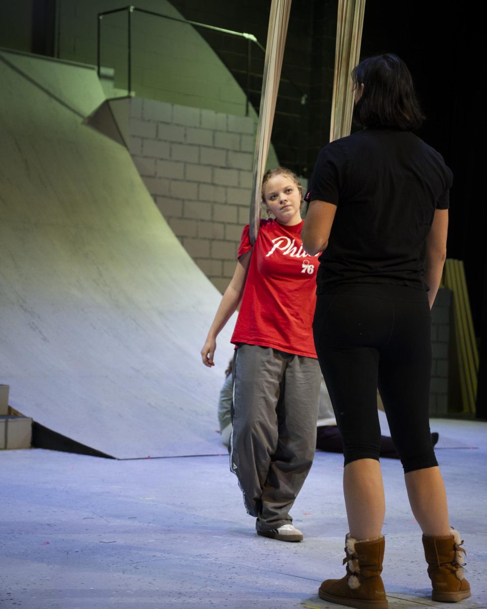 Hirlinger listening to Kaitlin Chin, the show's circus instructor