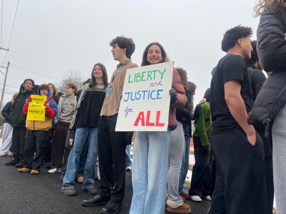 Una Davis '26 holding up a sign during the ICE protest. 