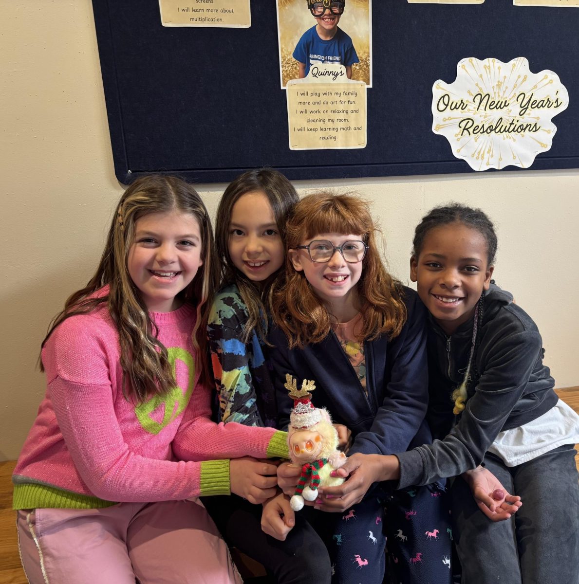Fourth graders crowding around a Labubu. “Labubus are my favorite toy because they make me feel happy because they are so fluffy and huggable.”