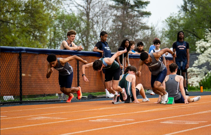 Students from the AFS Track Team racing at a spring meet.
