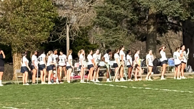 Girls lacrosse team lined up showing sportsmanship to the Friends' Central after a tough loss.