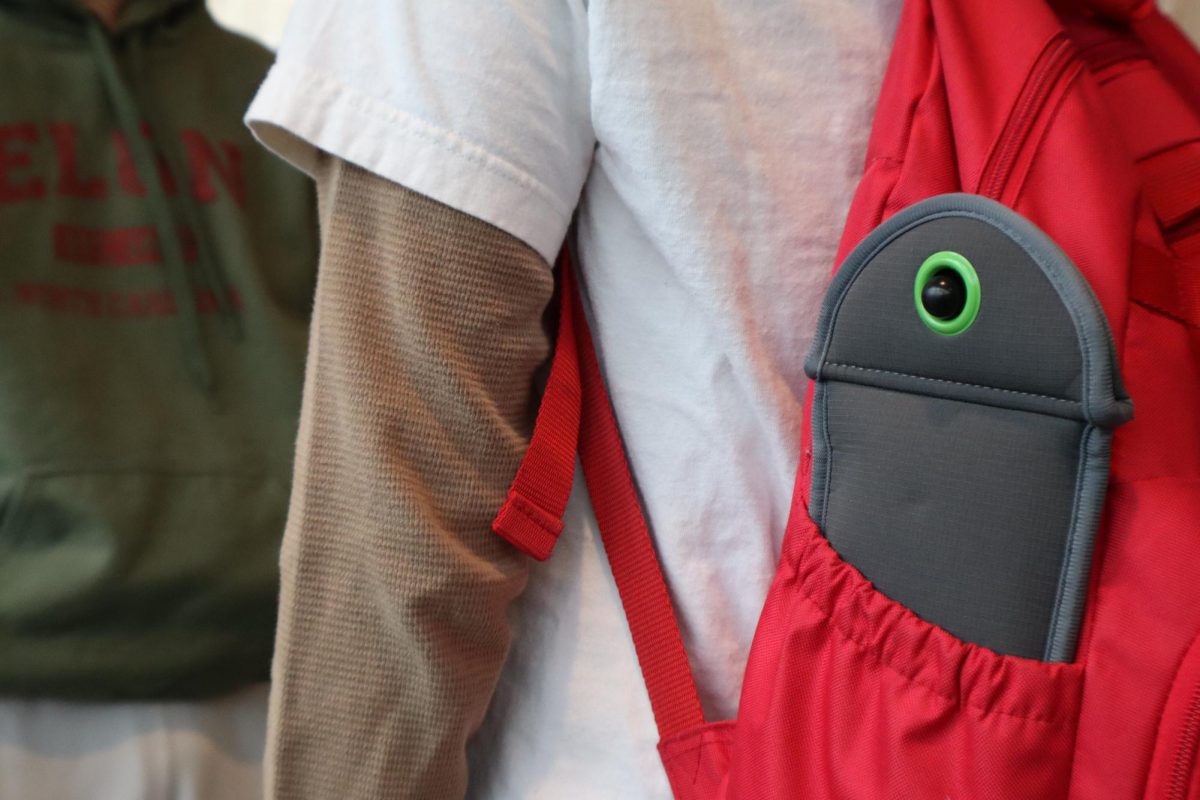 Photo of student showcasing a common way of carrying a Yondr Pouch in their bag.